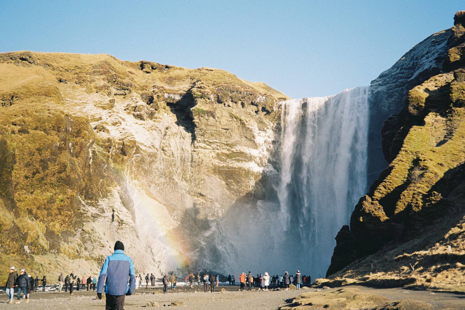 A photograph of a waterfall on a cliff