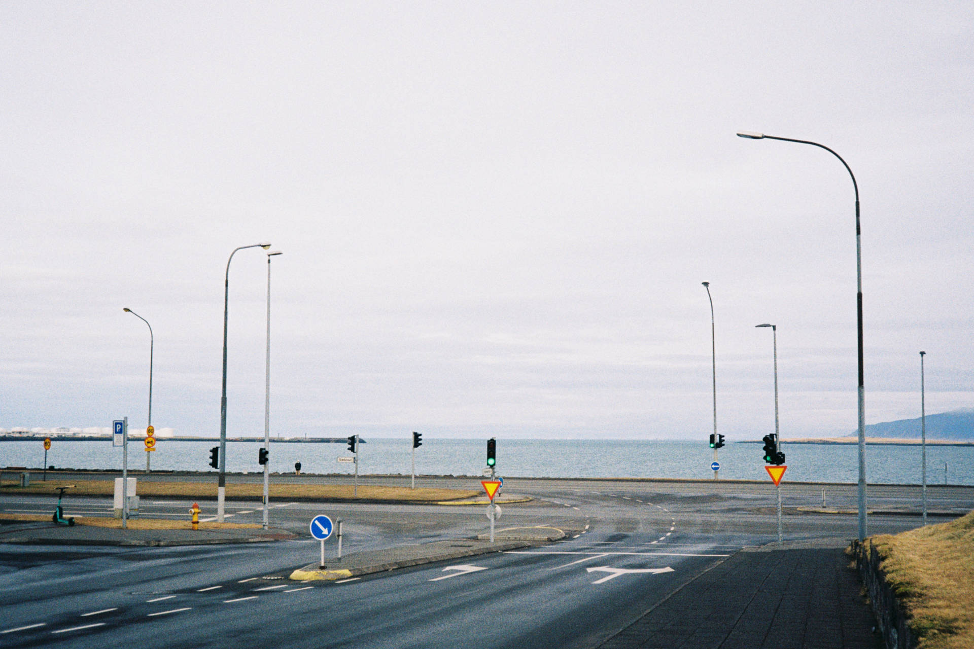 A photograph of an empty main road in Reykjavik looking out towards the sea