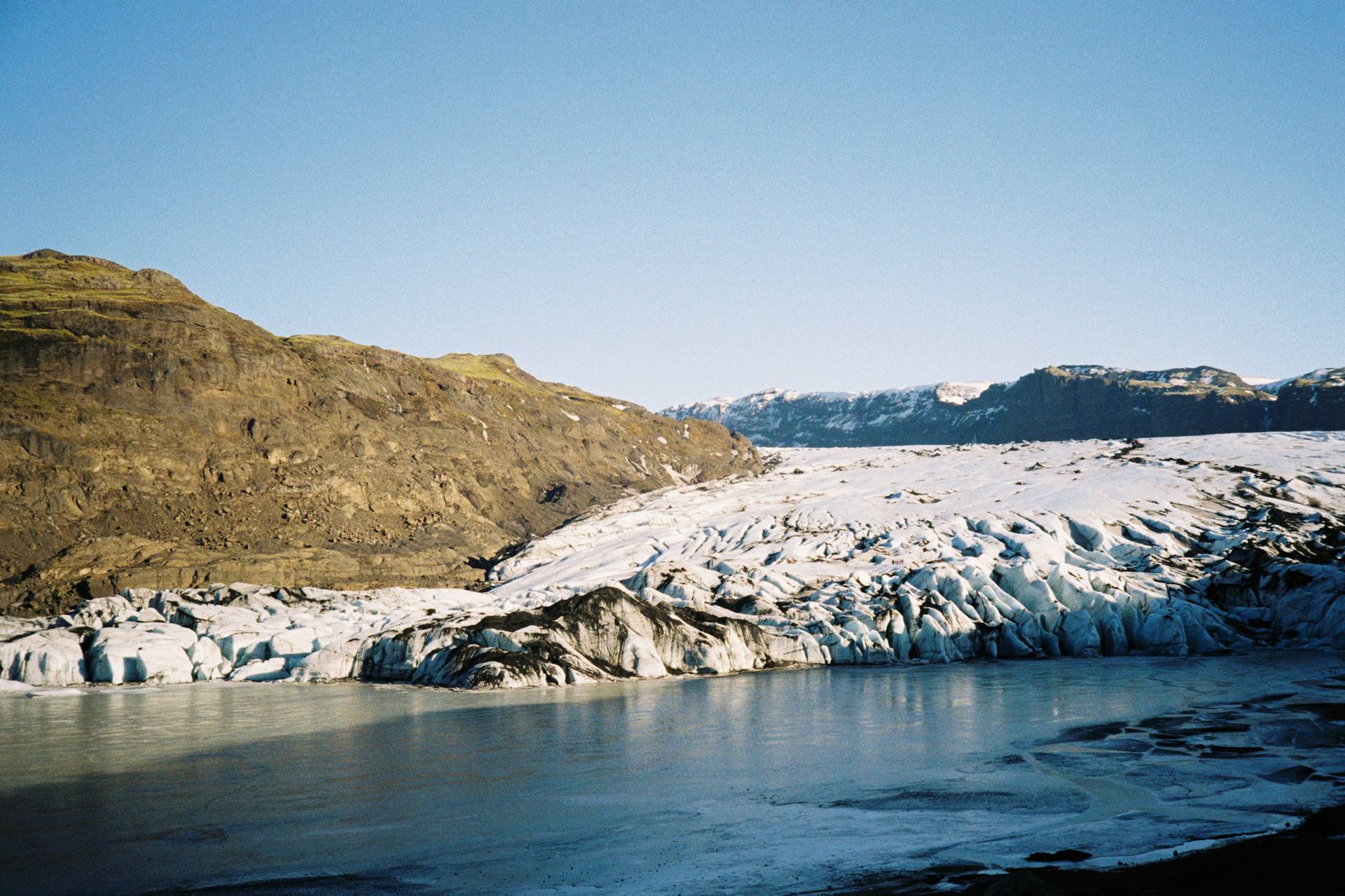 A photograph of a glacier, with an ice sheet in the foreground