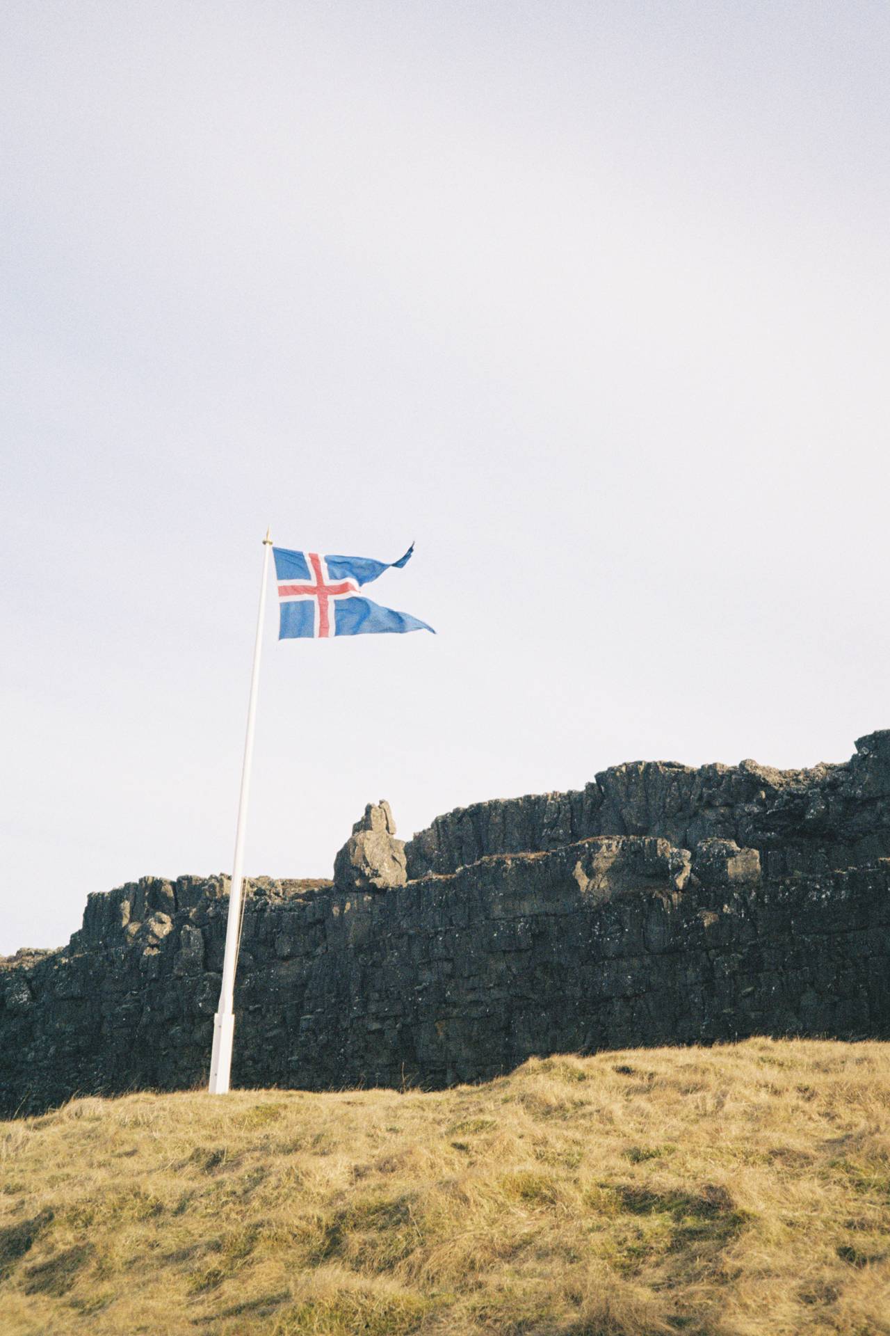 A photograph of the Icelandic flag, shaking in the wind
